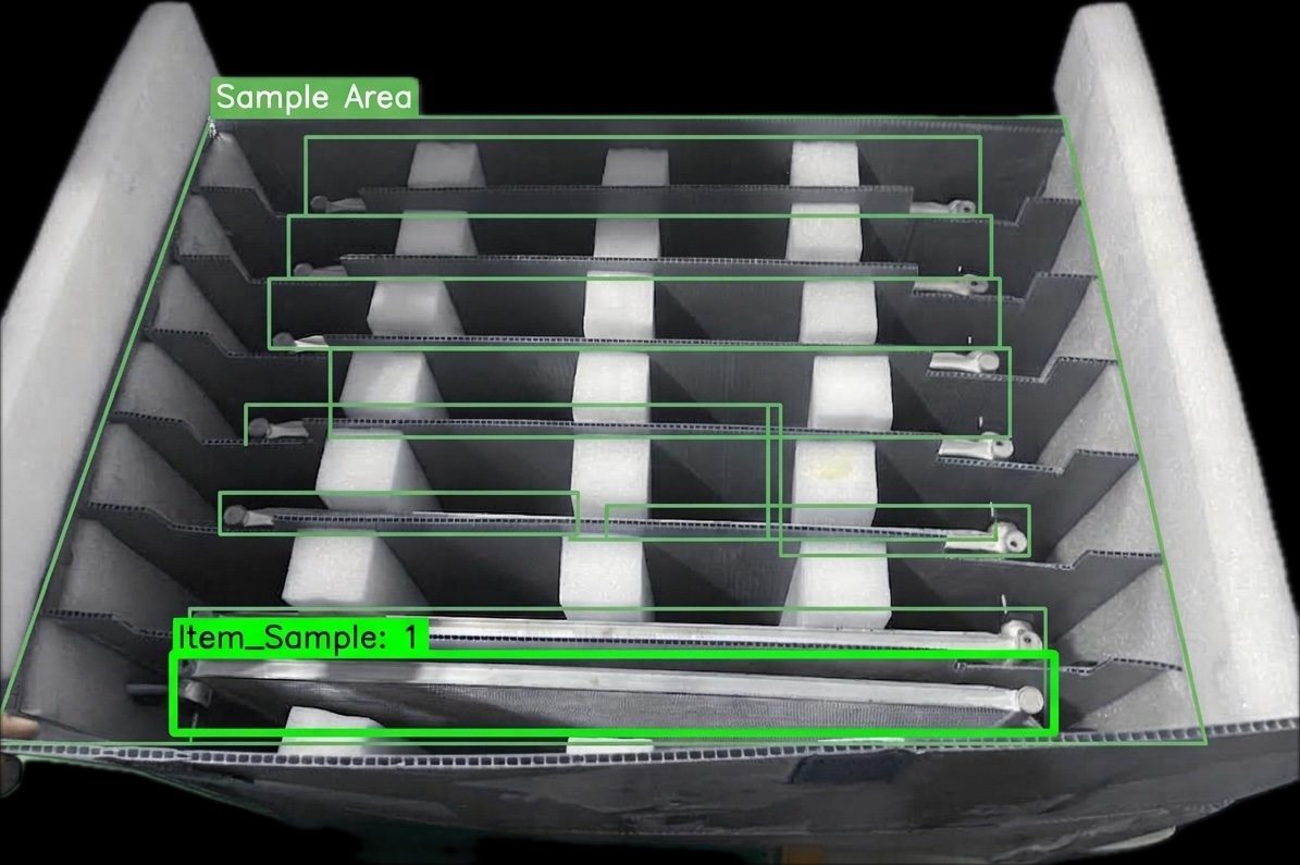Vision model detecting and counting individual parts inside a divided kitting tray, each item boxed within a defined sample area.